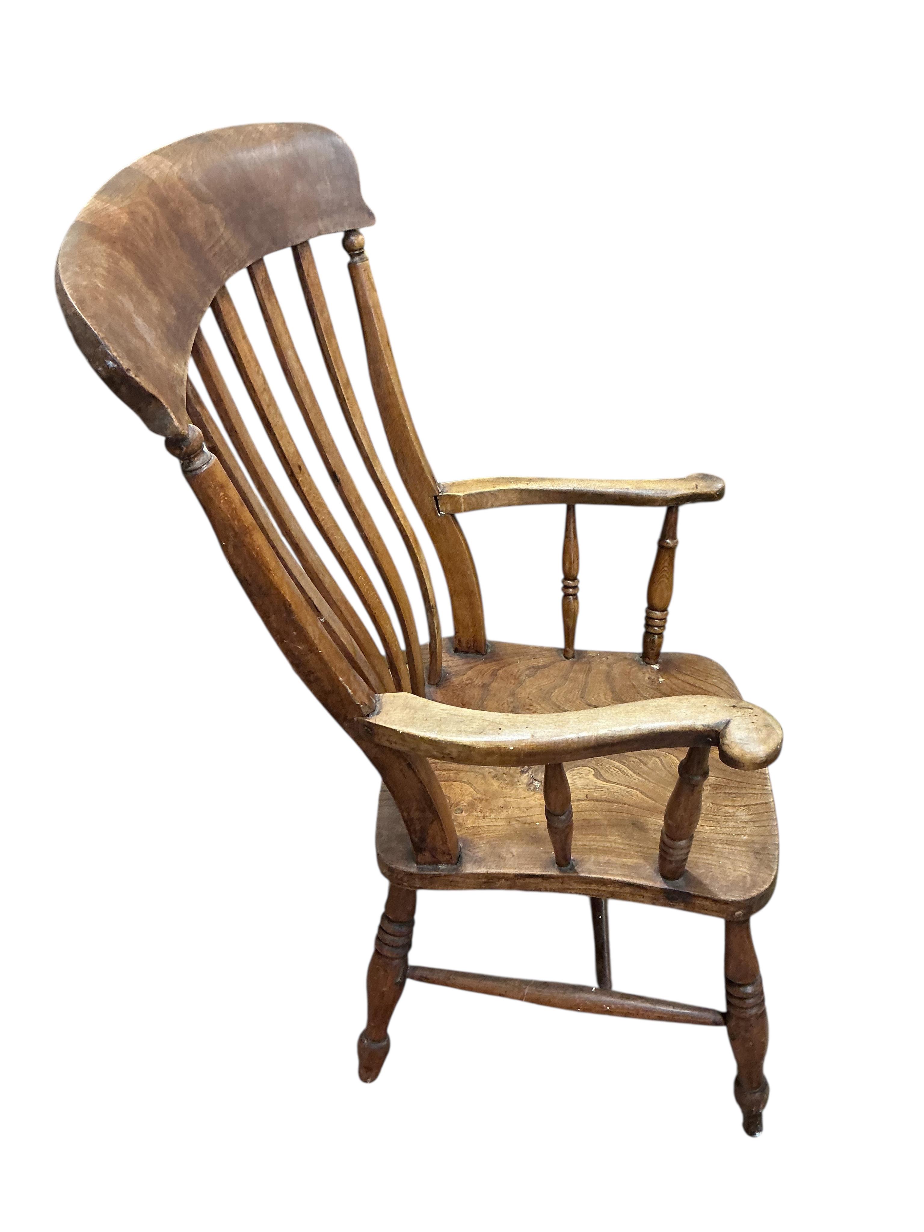 A near pair of Victorian elm and beech Windsor lathe back armchairs